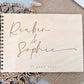 “Personalised wooden wedding guest book engraved with surname and date”

“Engraved basswood guest book with spiral binding”

“Rustic wooden wedding guest book on woven mat”