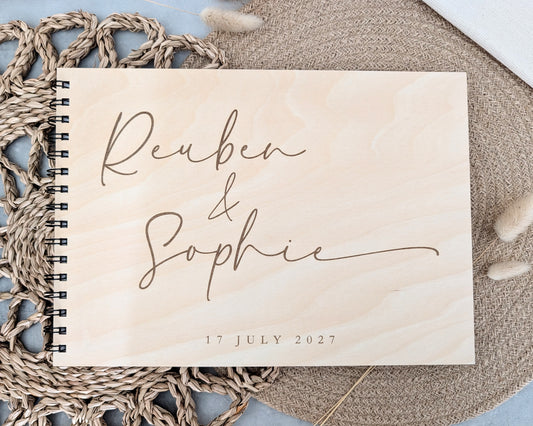 “Personalised wooden wedding guest book engraved with surname and date”

“Engraved basswood guest book with spiral binding”

“Rustic wooden wedding guest book on woven mat”
