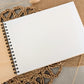 “Personalised wooden wedding guest book engraved with surname and date”

“Engraved plywood guest book with spiral binding”

“Rustic wooden wedding guest book on woven mat”

“Laser engraved basswood guest book cover”