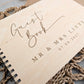 “Personalised wooden wedding guest book engraved with surname and date”

“Engraved plywood guest book with spiral binding”

“Rustic wooden wedding guest book on woven mat”

“Laser engraved basswood guest book cover”