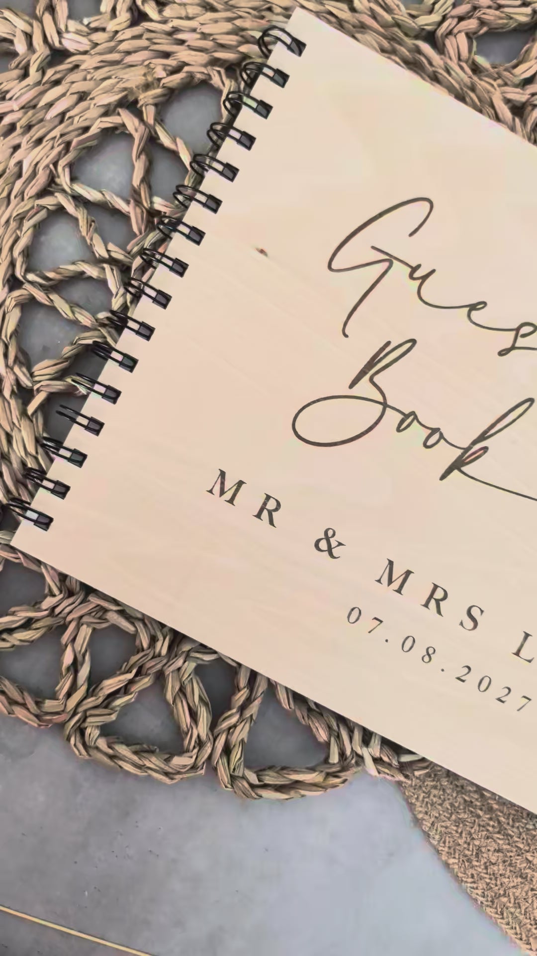 “Personalised wooden wedding guest book engraved with surname and date”

“Engraved plywood guest book with spiral binding”

“Rustic wooden wedding guest book on woven mat”

“Laser engraved basswood guest book cover”